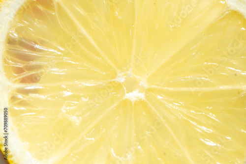 Close up of macro a slice piece of lemon abstract texture, background or banner for vitamin C in fruit serum, skin care, lotion, treatment, essence and medical body product advertise with copy space.