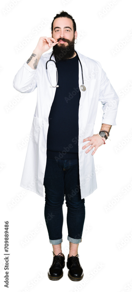 Doctor with long hair wearing medical coat and stethoscope mouth and lips shut as zip with fingers. Secret and silent, taboo talking Doctor with long hair wearing medical coat and stethoscope mouth and lips shut as zip with fingers. Secret and silent, taboo talking