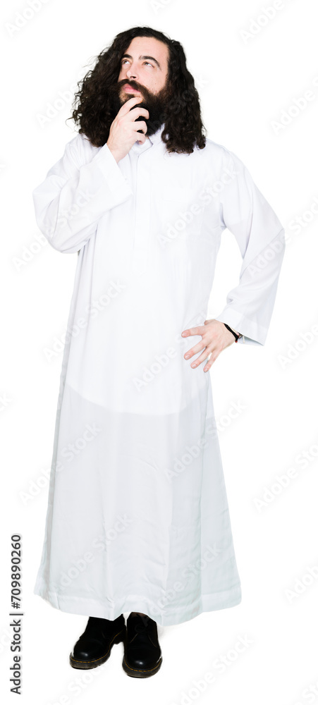 Man wearing Jesus Christ costume with hand on chin thinking about question, pensive expression. Smiling with thoughtful face. Doubt concept. Man wearing Jesus Christ costume with hand on chin thinking about question, pensive expression. Smiling with thoughtful face. Doubt concept.