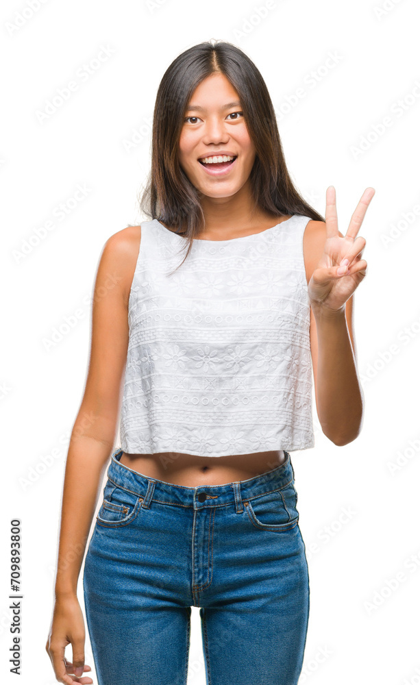 Young asian woman over isolated background smiling with happy face winking at the camera doing victory sign. Number two. Young asian woman over isolated background smiling with happy face winking at the camera doing victory sign. Number two.