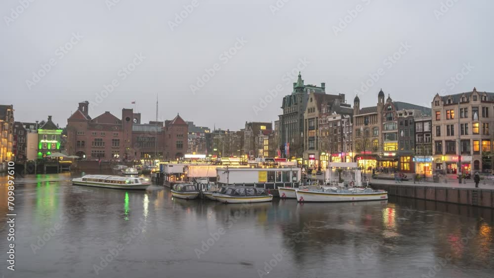 Amsterdam Netherlands time lapse, city skyline day to night timelapse at Damrak canal waterfront Amsterdam Netherlands time lapse, city skyline day to night timelapse at Damrak canal waterfront