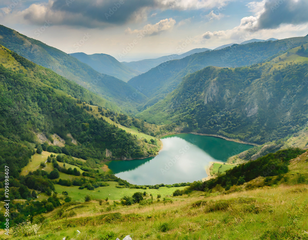 nature scene with lake in valley surrounded by green mountains