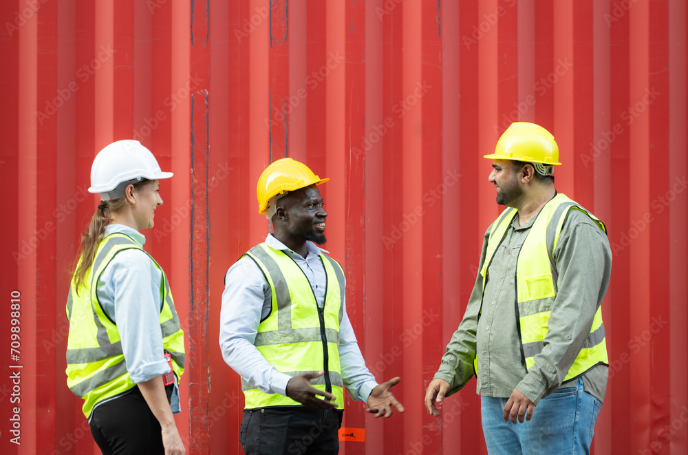 Group of workers in a container storage yard greeting each other during breaks in front of container warehouse, Group of workers in a container storage yard greeting each other during breaks in front of container warehouse,