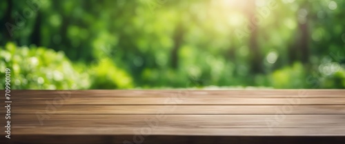 Wooden table and blurred green nature garden background photo