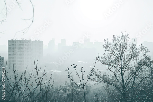 Light gray cityscape background. City buildings with trees at park view. Monochrome urban landscape with street.