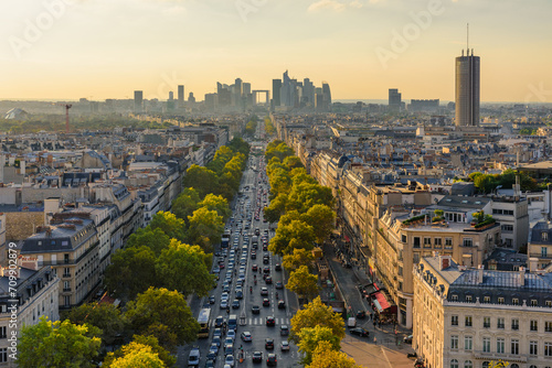 Aerial view of Paris with Eiffel Tower and Champs Elysees from the roof of the Triumphal Arch. Panoramic sunset view of old town of Paris. Popular travel destination photo