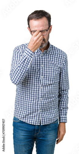 Handsome middle age elegant senior business man wearing glasses over isolated background tired rubbing nose and eyes feeling fatigue and headache. Stress and frustration concept. © Krakenimages.com