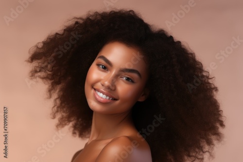 Black History Month, african american girl beauty portrait, clean healthy skin on beige background. Smiling beautiful woman. Curly hair