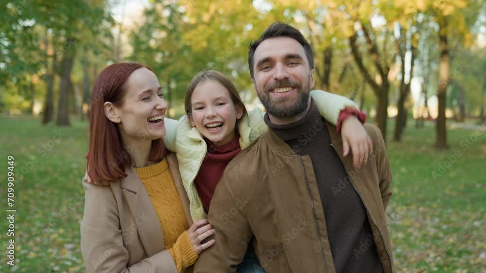 Happy Caucasian family parents with daughter at holiday weekend in park autumn outdoors together laughing smiling spending time at nature portrait father hold child girl kid piggyback cuddling people Happy Caucasian family parents with daughter at holiday weekend in park autumn outdoors together laughing smiling spending time at nature portrait father hold child girl kid piggyback cuddling people