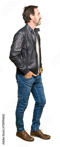 Middle age handsome man wearing black leather jacket looking to side, relax profile pose with natural face with confident smile.