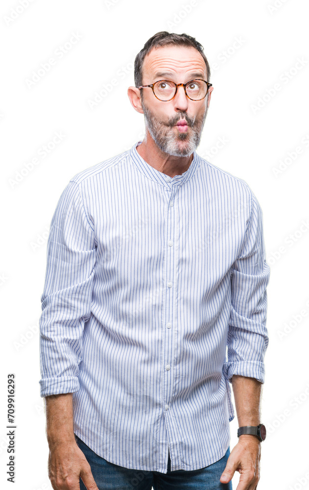 Middle age hoary senior man wearing glasses over isolated background making fish face with lips, crazy and comical gesture. Funny expression. Middle age hoary senior man wearing glasses over isolated background making fish face with lips, crazy and comical gesture. Funny expression.