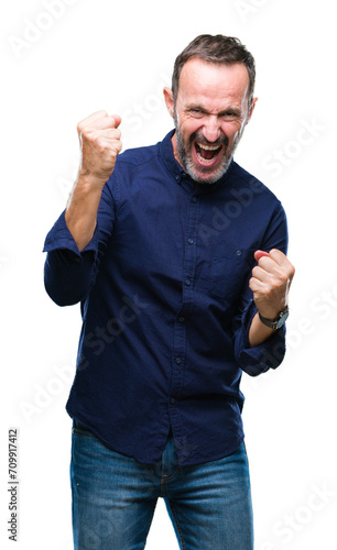 Middle age hoary senior man over isolated background very happy and excited doing winner gesture with arms raised, smiling and screaming for success. Celebration concept.