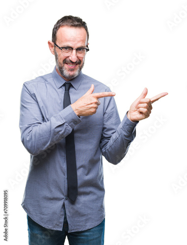 Middle age hoary senior business man wearing glasses over isolated background smiling and looking at the camera pointing with two hands and fingers to the side.