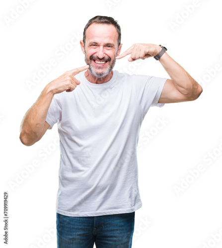 Middle age hoary senior man wearing white t-shirt over isolated background smiling confident showing and pointing with fingers teeth and mouth. Health concept.