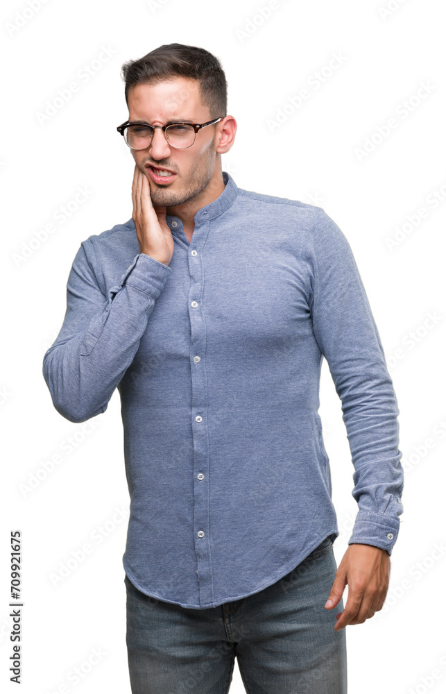 Handsome young elegant man wearing glasses touching mouth with hand with painful expression because of toothache or dental illness on teeth. Dentist concept. Handsome young elegant man wearing glasses touching mouth with hand with painful expression because of toothache or dental illness on teeth. Dentist concept.