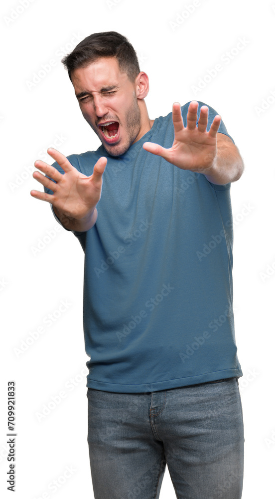 Handsome young casual man afraid and terrified with fear expression stop gesture with hands, shouting in shock. Panic concept. Handsome young casual man afraid and terrified with fear expression stop gesture with hands, shouting in shock. Panic concept.
