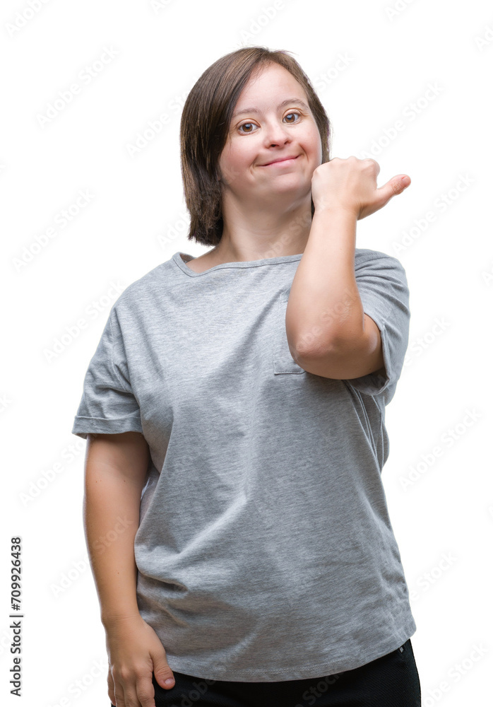 Young adult woman with down syndrome over isolated background smiling with happy face looking and pointing to the side with thumb up. Young adult woman with down syndrome over isolated background smiling with happy face looking and pointing to the side with thumb up.