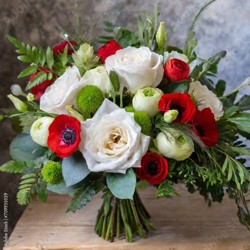 bouquet of flowers with white roses  red anemones  and greenery