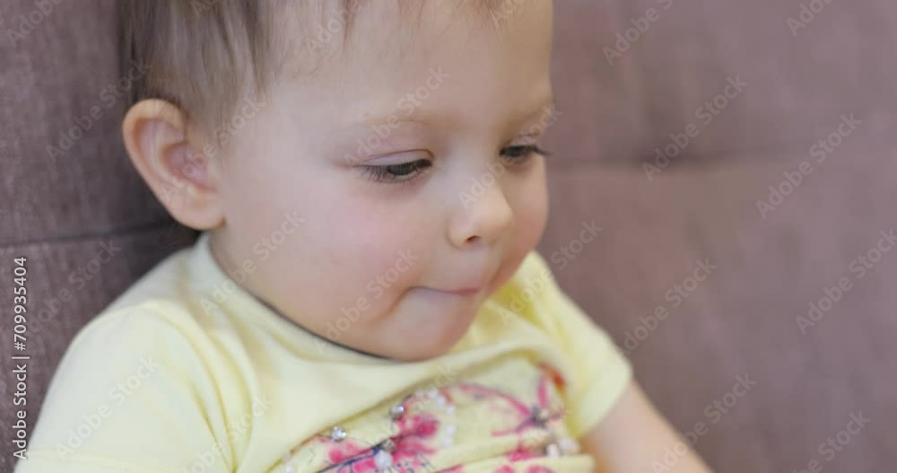 little baby child watching tv sitting on coach at home little baby child watching tv sitting on coach at home