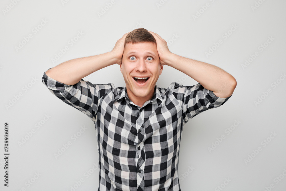 Portrait of smiling face man touching head and rejoicing, celebrating victory isolated on white studio background, advertising banner. Portrait of smiling face man touching head and rejoicing, celebrating victory isolated on white studio background, advertising banner.