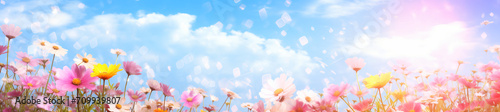 The colorful flowers and sky together with sunlight, in the style of digital airbrushing, bokeh panorama, realistic blue skies, soft-edged, small brushstrokes, tilt shift, organic and flowing forms


