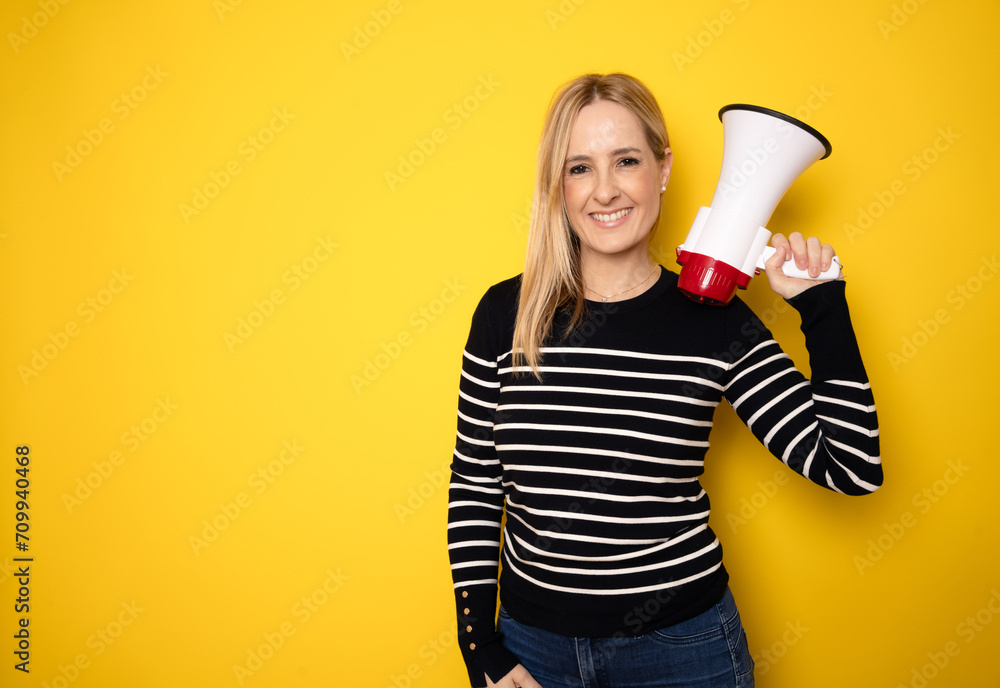 Young woman holding a megaphone. People sincere emotions lifestyle concept. Mock up copy space. Screaming in megaphone Young woman holding a megaphone. People sincere emotions lifestyle concept. Mock up copy space. Screaming in megaphone