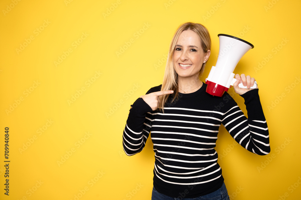 Young woman holding a megaphone. People sincere emotions lifestyle concept. Mock up copy space. Screaming in megaphone Young woman holding a megaphone. People sincere emotions lifestyle concept. Mock up copy space. Screaming in megaphone