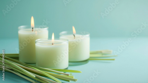 Patchouli scented aroma burning candles with flowers on a blue background 