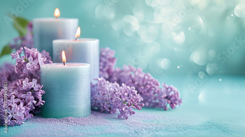 Lilac scented aroma burning candles with lilac flowers on a blue background 