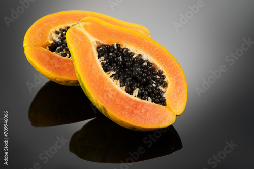 Papaya fruit on black background. Fresh organic Papaya exotic fruits close up. Healthy vegan papayas 