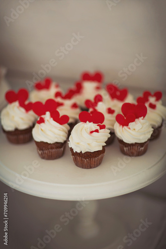 Candy bar with different assortments of cakes. Delicious sweets on wedding candy buffet with desserts, cupcakes. Desserts, different types of sweet pastries small colorful sweet cakes