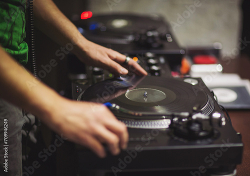 dj hands on professional music equipment deck vinyl record turntable and timecode. Close up shot vintage vinyl party dj audio equipment. Sound mixing controller disc jockey in night club party.