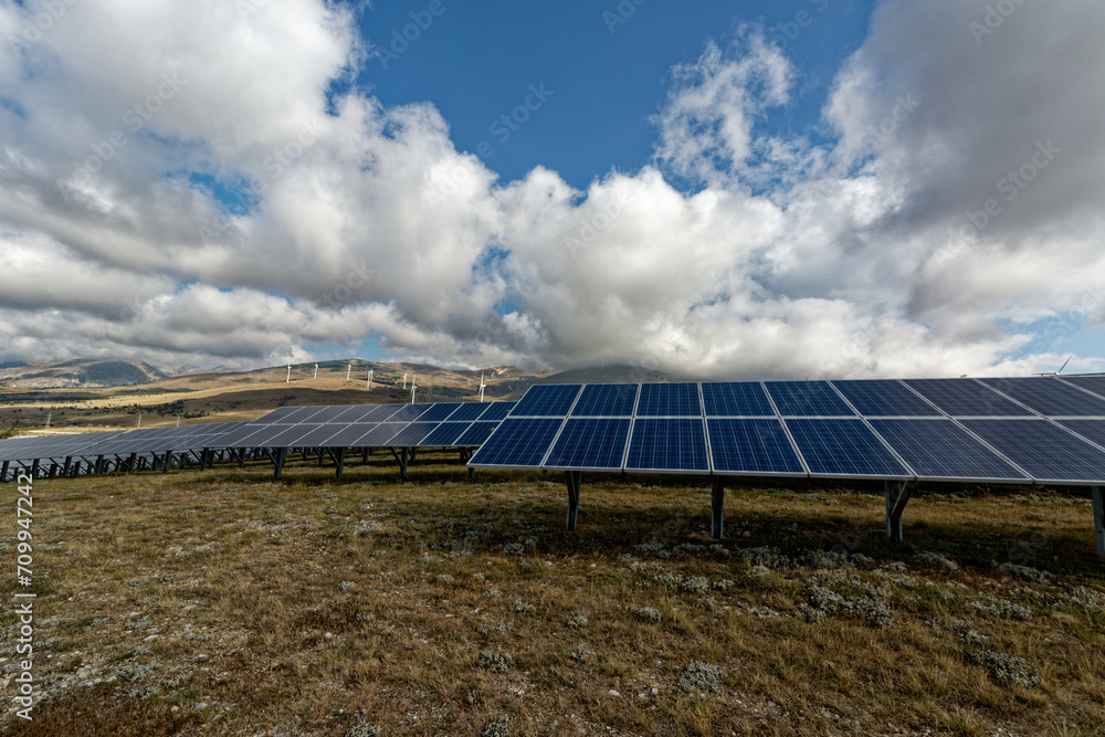 Photovoltaic system and a wind farm. Solar and Wind power are the use of solar and wind for electrical power. Popular sustainable, renewable energy for enviromental energy batteries generated megawatt Photovoltaic system and a wind farm. Solar and Wind power are the use of solar and wind for electrical power. Popular sustainable, renewable energy for enviromental energy batteries generated megawatt