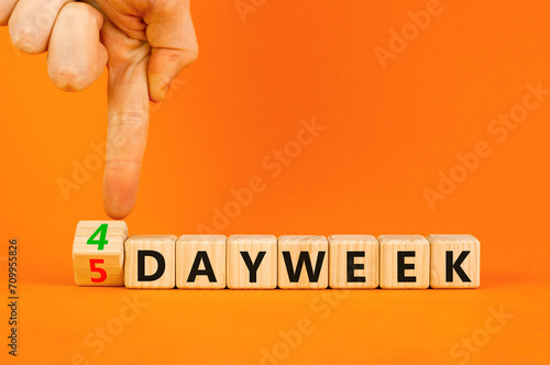 4 or 5 work day per week symbol. Concept words 5 day week or 4 day week on beautiful wooden cubes. Beautiful orange table orange background. Business and 4 or 5 day work week concept. Copy space.