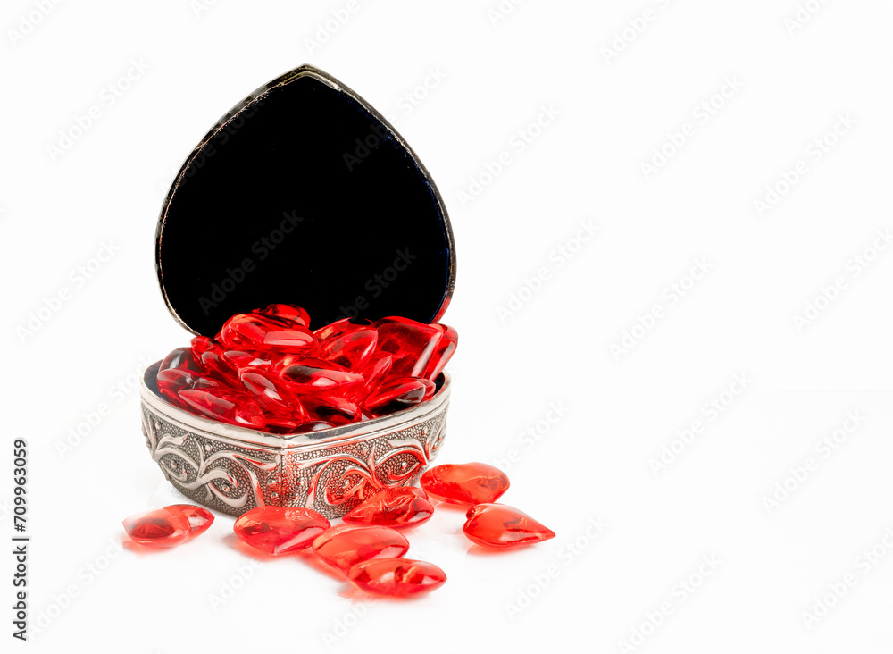 antique silver case filled with ruby red hearts for valentines day isolated on a white background antique silver case filled with ruby red hearts for valentines day isolated on a white background