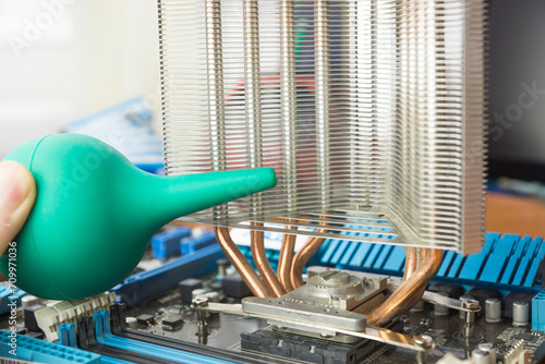 Technician Using a Blower to Clean Dust From a Computers Heat Sink