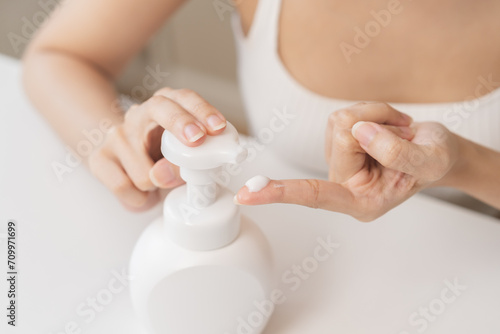 Canvastavla Healthy skin care,beauty asian young woman with lotion after shower bath at home, squeeze out moisturizer from bottle, putting on her hand