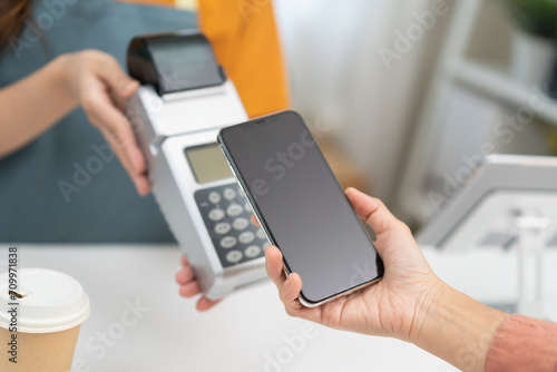 Pay, cashless technology concept, customer using smart mobile phone for payment, paying money to transfer cashless at cafe shop to buy breakfast, holding wireless bank machine at counter cashier.