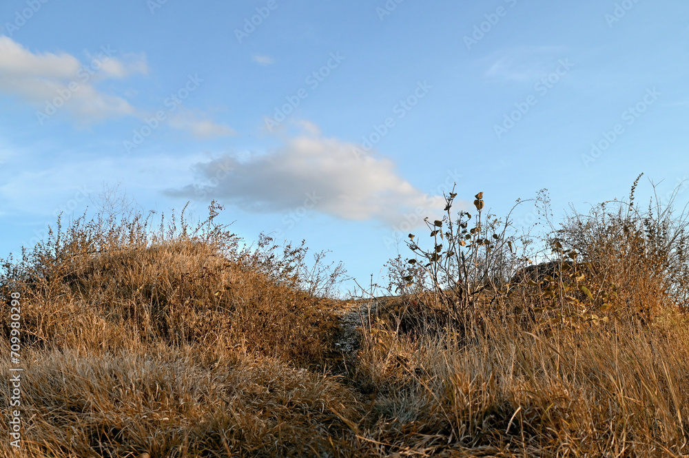 A cloud over a grassy slope in autumn. The path to sky. A cloud over a grassy slope in autumn. The path to sky.