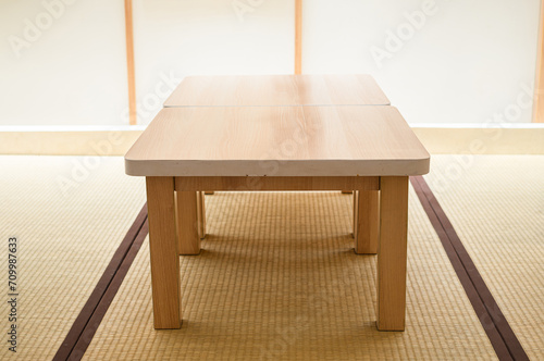 Wooden table on the Zashiki or a type of cross-legged seating in Japan for rooms that use tatami floors photo