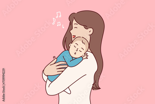 Mother sings lullaby to newborn son, holding sleeping baby in arms and feeling happiness of motherhood. Happy woman became mother sings lullaby to help little kid in need of rest fall asleep