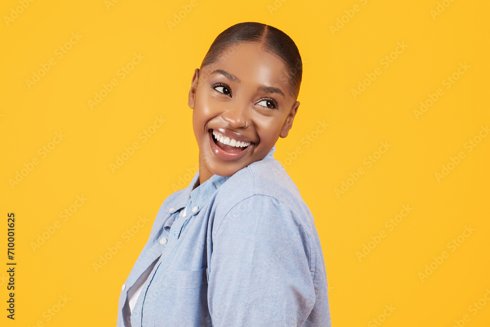 Portrait of playful pretty black woman smiling looking aside, studio Portrait of playful pretty black woman smiling looking aside, studio