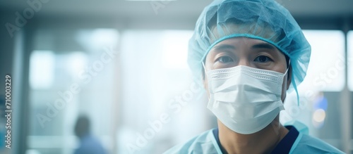 An Asian doctor in a hospital wearing a PPE suit and face mask during the virus outbreak.
