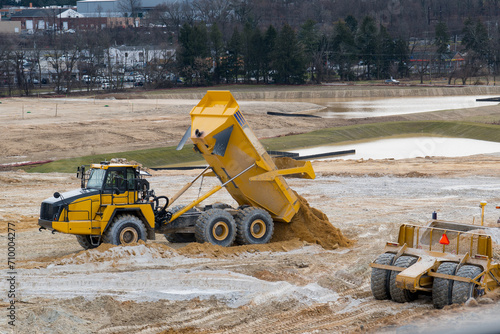 dump truck unloading sand in a quarry