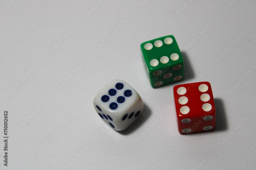 Close up of three different colored dice red, green, and white isolated on white background Close up of three different colored dice red, green, and white isolated on white background