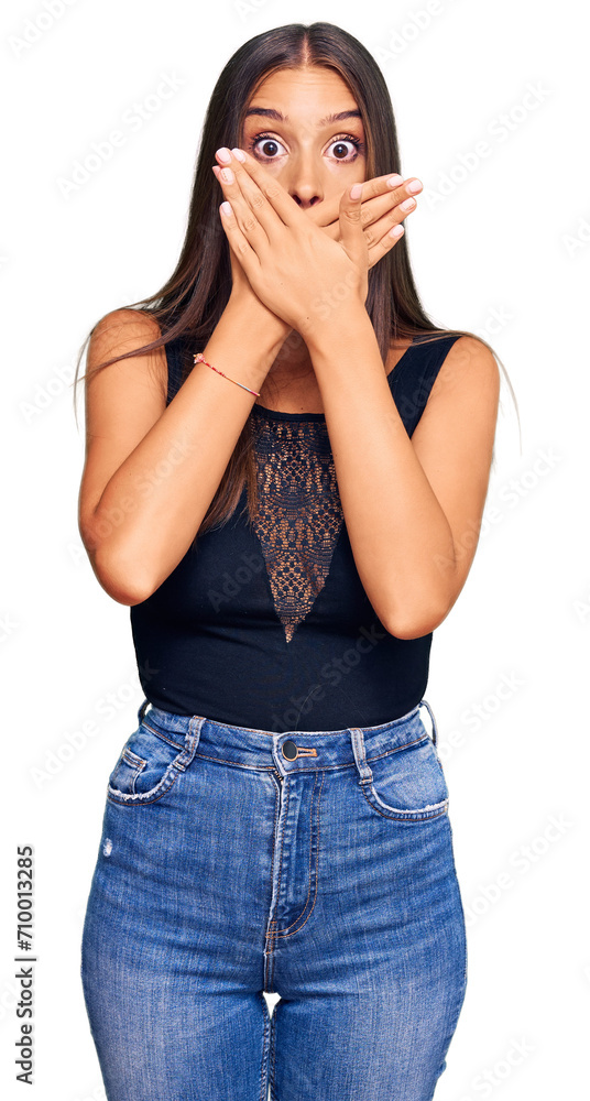 Young hispanic woman wearing casual clothes shocked covering mouth with hands for mistake. secret concept. Young hispanic woman wearing casual clothes shocked covering mouth with hands for mistake. secret concept.