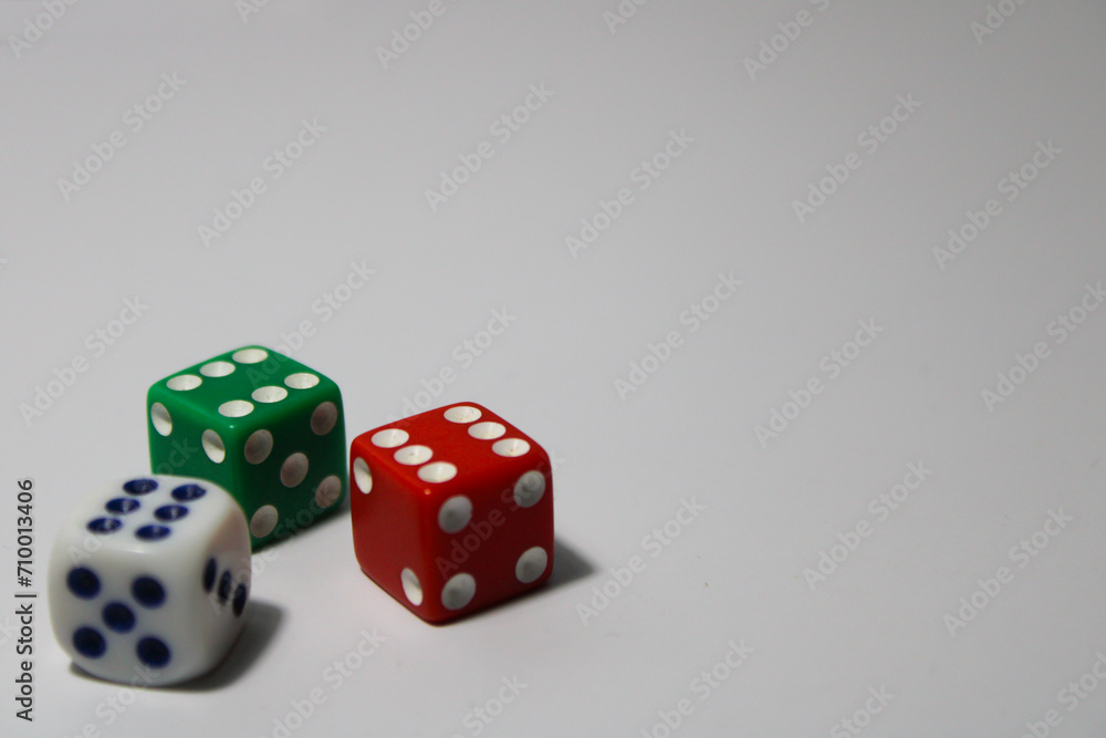 Close up of three different colored dice red, green, and white isolated on white background Close up of three different colored dice red, green, and white isolated on white background