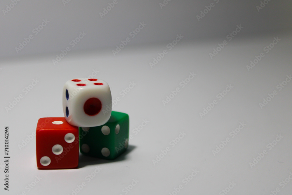 Close up of three different colored dice red, green, and white isolated on white background