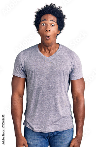 Handsome african american man with afro hair wearing casual clothes afraid and shocked with surprise expression, fear and excited face.