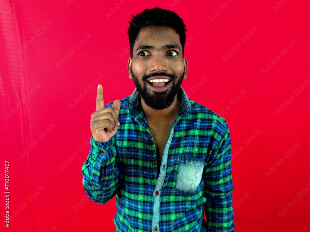 Naklejka premium young man thinking got an idea very excited and happy against red background